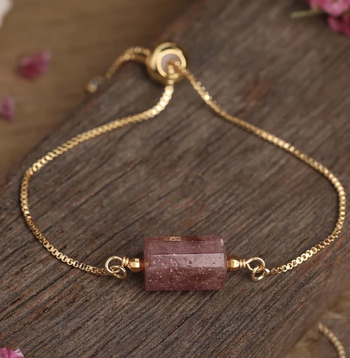 Natural Strawberry Quartz Gem Cylinder stone on a Gold pull-chain Bracelet Our Beautiful Gold plated adjustable Pull-chain bracelets are so elegant and delicate for all Occasions. We have chosen a variety of the most powerful Gemstones and created little Cylinders to sit perfectly on your wrist. They are very special pieces of jewellery and also make exquisite gifts. Strawberry Quartz-